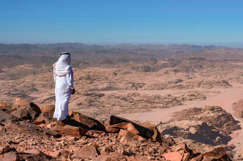 bedouin standing in the summit Jabal Umm ad Dami